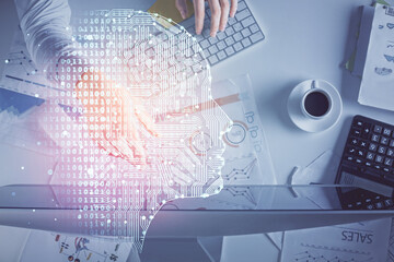 Double exposure of man's hands typing over computer keyboard and brain hologram drawing. Top view. Ai and data technology concept.