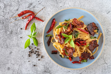Top view of stir fired spicy spaghettis with crunch bacon for menu background