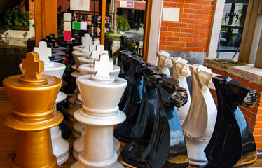 Outdoor oversized chess in public area zone of restaurant, Selective focus some chess spot. This is on of the shop decoration style. 