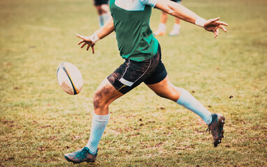 rugby player preparing to kick the oval ball during game