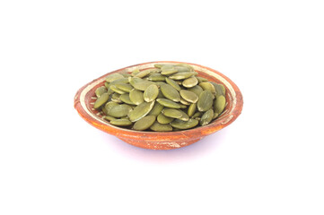 Pepitas or Huskless Green Pumpkin Seeds in Orange Pottery Bowl Isolated on White Background