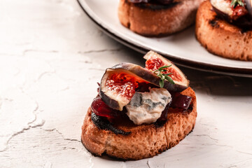 Set Bruschettas with figs and goat cheese, Blue cheese and nuts, onion jam, fresh thyme, honey on grilled crusty bread