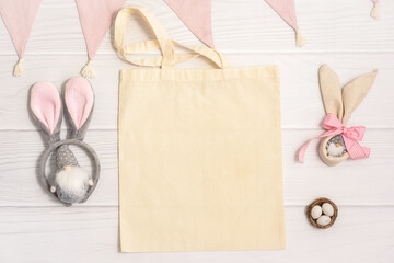 Flatlay mockup Easter composition Shopping bag with gnome bunny ears and eegs on white background...