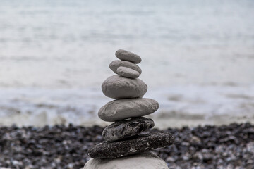 A rock cairn at the coast, with a shallow depth of field