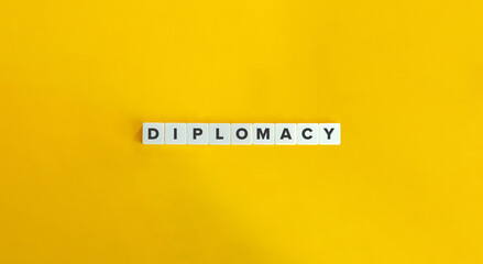 Diplomacy Word on Letter Tiles on Yellow Background. Minimal Aesthetics.