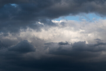 White cumulus cloud framed with dark ominous clouds - cloudscape