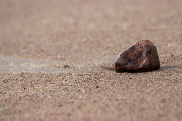 Fototapeta na wymiar Stone on the sand