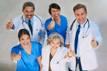 Well keep you on the up and up. High angle portrait of a medical team standing with their thumbs up...