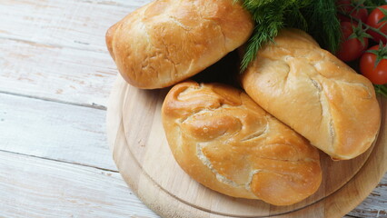 Ukrainian Patties (Pasties, Hot Cakes, Pirozhki, Pies) on wooden cupboard . Traditional homemade backed pies  with meat