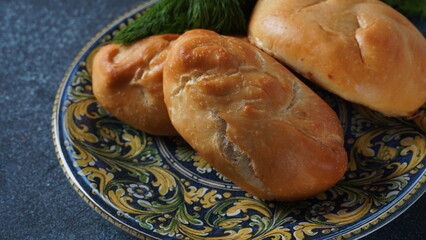 Ukrainian Patties (Pasties, Hot Cakes, Pirozhki, Pies) on a plate. Traditional homemade backed pies  with meat