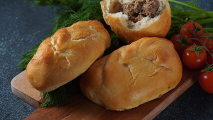 Ukrainian Patties (Pasties, Hot Cakes, Pirozhki, Pies) on a plate. Traditional homemade backed pies  with meat