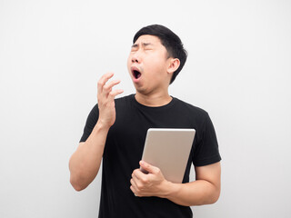 Man holding tablet yawn and feeling sleepy