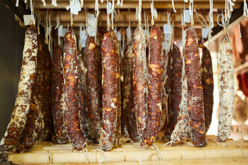 Production line of sausage products. Sausage hanging on the counter of the store. Meat products