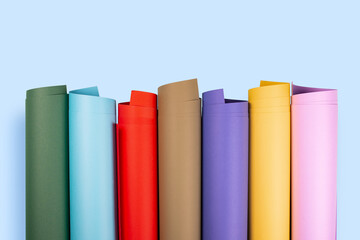 Rolls of color paper on blue background.