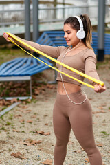 Woman. Resistance Band For Fitness Workout. Fit Girl In Fashion Sporty Outfit Exercising Outside. Female Latin Athletic Muscular Body Training Outdoor. Urban People And Active Lifestyle.