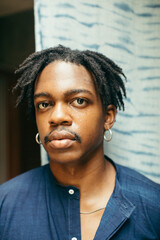 Obraz premium Portrait of a Young black eco fashion designer sitting and looking into camera