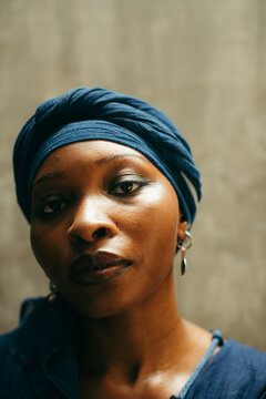 Close up beauty portrait of a african woman eco fashion designer looking into the camera