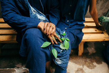 African womans hands holding a indigo plant