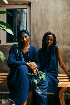Portrait of a pair of african female eco fashion designers sitting 