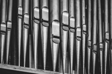 Grayscale closeup of the organ pipes.