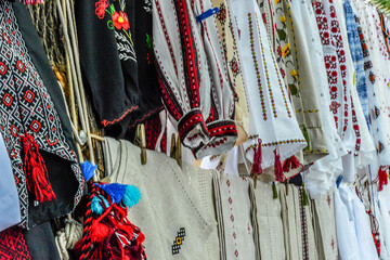 Number of colorful traditional costumes and clothes in a flea market in Ukraine