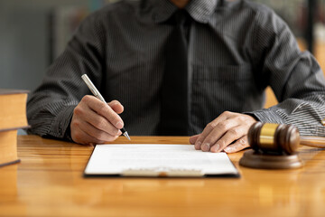 Attorneys are reviewing contract documents for the client, in which the client has filed a lawsuit against an employee at a company that commits the fraud. Lawyer and use of law properly and fairly.