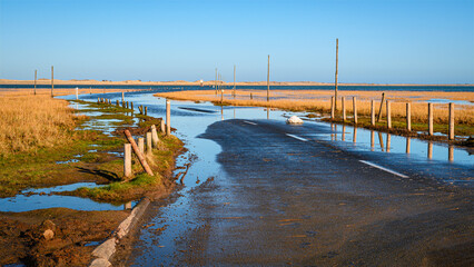 Lindisfarne Causeway is submerged at high tide, as part of the coastal section on the...