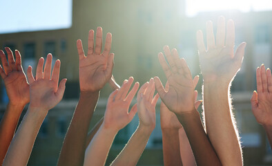 We are one. Cropped shot of a diverse group of people raising their hands.