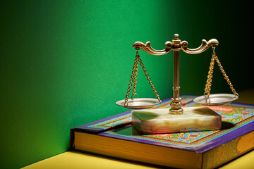 sharia law - libra scale and holy koran