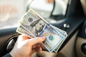Businessman in model on stack of dollar bil, in business, saving money in hand concept