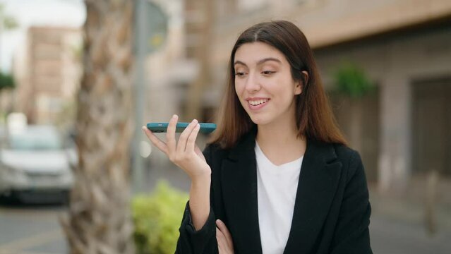 Young hispanic girl smiling confident talking on the smartphone at street