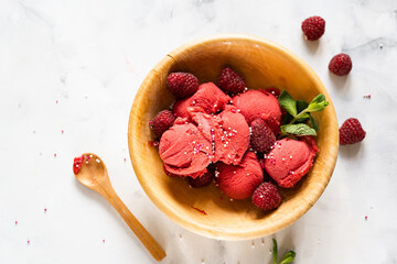 Delicious raspberry sorbet in wooden bowl on white table. Top view. Summer concept - obrazy, fototapety, plakaty