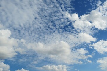 Beautiful white curly clouds in blue sky, natural background