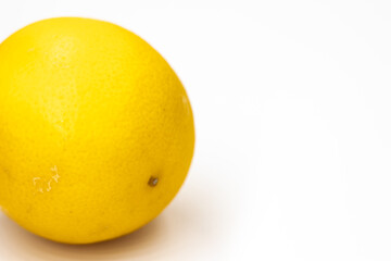 One whole citrus fruit a hybrid of orange and lemon in light orange color on a white background close-up