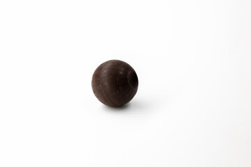 One round brown chocolate candy isolated on white background close-up