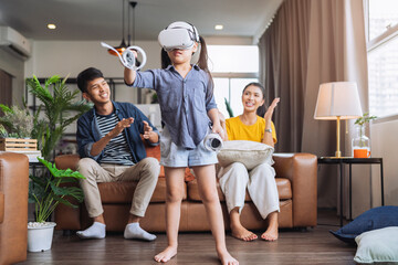 exiting daugther wear vr headset playing virtual gaming sport innovation while her parent sit and...