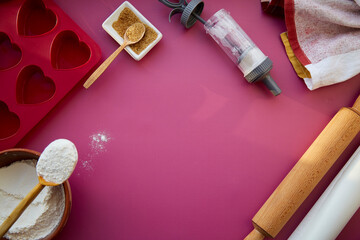 Baking equipment complete heart-shaped silicone mold, rolling pin, confectionery syringe, glaze, flour, sugar. Copy space.