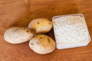 White Potatoes And White Rice On Board Surface