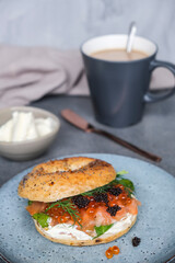 Delicious and healthy homemade meal. Bagel Sandwich with Smoked Salmon, Ikura Salmon Roe and Black Caviar. 