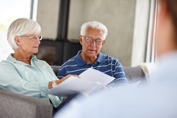 Save a penny, earn a penny. Over-the-shoulder shot of a financial advisor meeting with a senior...