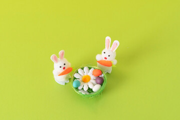 Easter composition with decorative rabbits and eggs in the nest. Background for your project for the holiday happy easter