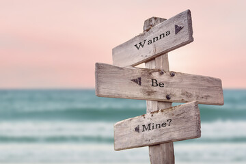 wanna be mine text quote written on wooden signpost by the sea. Positive pink turqoise pastel theme. - obrazy, fototapety, plakaty