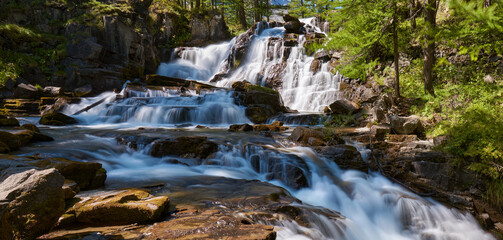 Fontcouverte Waterfall in the Claree Valley in summer. Vallée de la Clarée in Hautes Alpes...