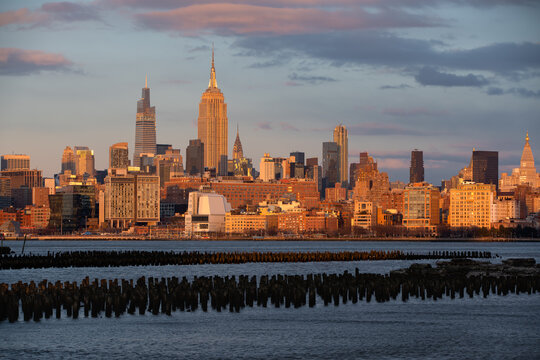 Sunset light on historic skyscrapers of Midtown Manhattan. New York City cityscape from across the Hudson River