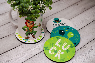 A mug with the image of a leprechaun and a quatrefoil, a horseshoe for happiness and good luck....