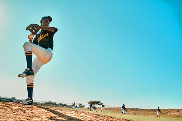 Get ready. Shot of a young baseball player pitching the ball during a game outdoors.
