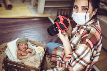 Female photographer taking photos of an infant in a photoshoot