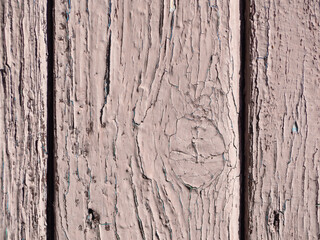 Wooden painted boards as an abstract background. Boards with peeling and sun-bleached brown paint. Texture of old painted boards