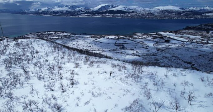 Orbit motion of hikers enjoying the breathtaking landscape on a mountain peak in Sortland with background view of Vester&aring;len, Norway, Northern Scandinavia.