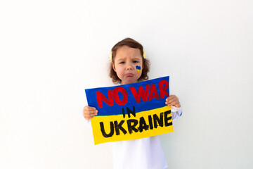 A portrait of a girl in an embroidered shirt calls to stop the war in Ukraine, raises a banner with the inscription "Stop the war in Ukraine", No war, stop the war, Russian aggression. 